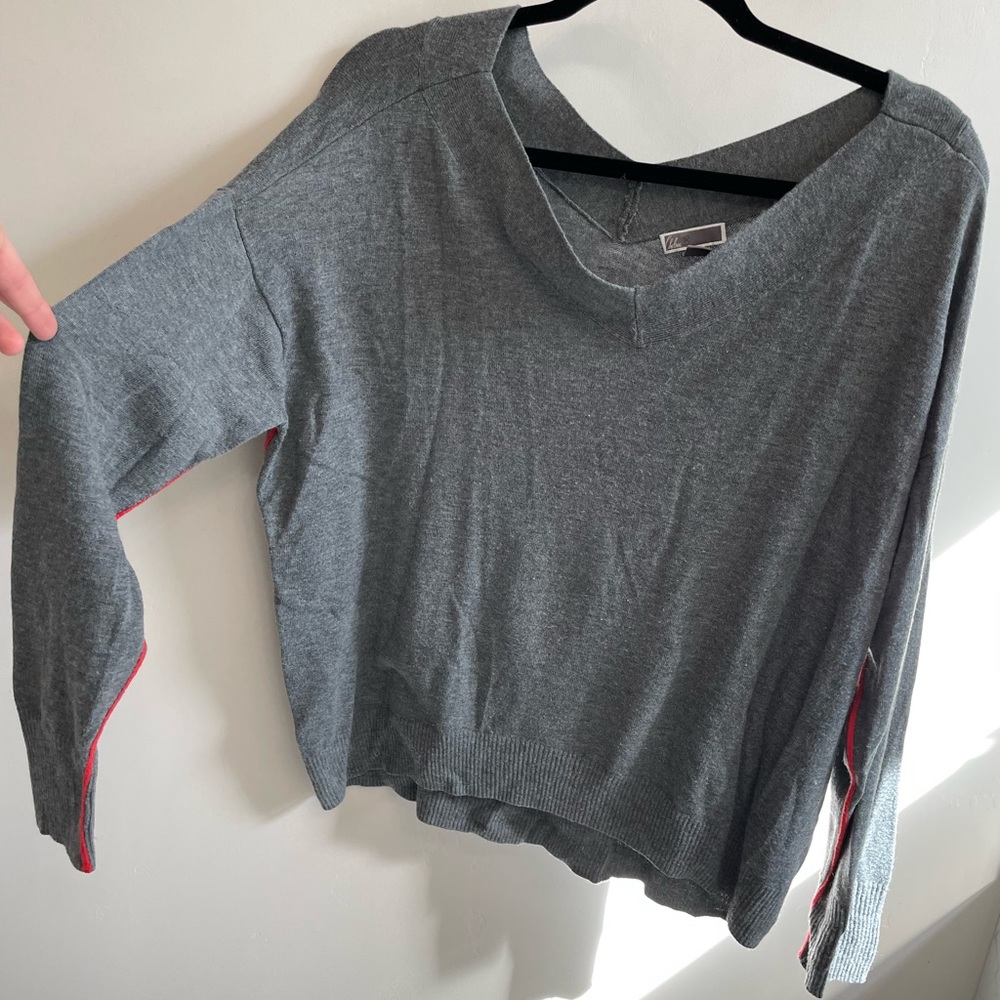 Very soft gray V-neck with subtle orange/red stripe on arms